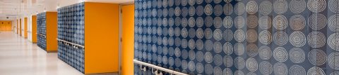 Hallway walls covered in decorative blue, white, orange glass finishes