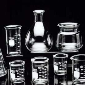 Clear glass labware in various shapes against black background